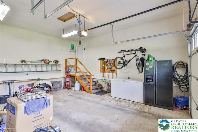 142 Hickory Ln, Chestnuthill Twp, PA 18353 - garage with black fridge with ice dispenser, a garage door opener, and fridge