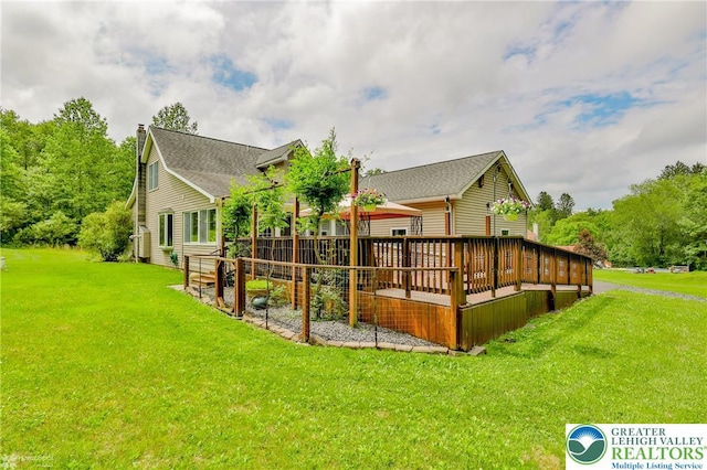142 Hickory Ln, Chestnuthill Twp, PA 18353 - rear view of house with a deck and a lawn