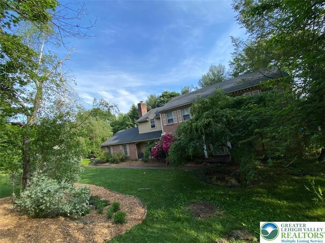 4804 Parkview Dr S, Lower Macungie Twp, PA 18049 - back of house with a lawn, a chimney, and brick siding