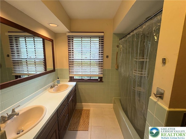 4804 Parkview Dr S, Lower Macungie Twp, PA 18049 - bathroom with tile walls, tile patterned floors, double vanity, wainscoting, and shower / tub combo