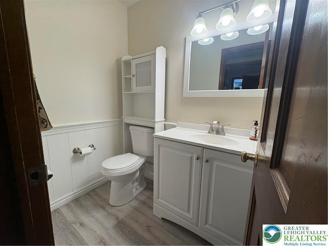 4804 Parkview Dr S, Lower Macungie Twp, PA 18049 - half bath featuring a wainscoted wall, vanity, wood finished floors, and a decorative wall