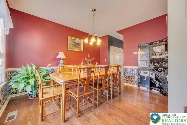 2130 Eagles Landing Dr, Upper Nazareth Twp, PA 18064 - dining area with wood finished floors, a wainscoted wall, a chandelier, and wallpapered walls
