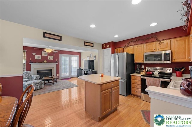 4583 Jasmine Dr, Upper Saucon Twp, PA 18034 - kitchen featuring stainless steel appliances, light countertops, a center island, open floor plan, and light wood-style flooring