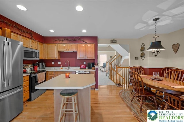 4583 Jasmine Dr, Upper Saucon Twp, PA 18034 - kitchen featuring stainless steel appliances, light countertops, light wood-style floors, a kitchen island, and recessed lighting