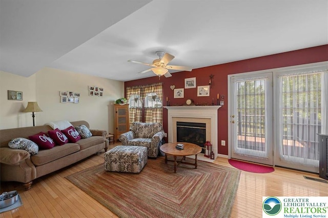 4583 Jasmine Dr, Upper Saucon Twp, PA 18034 - living area featuring a glass covered fireplace, wood-type flooring, and ceiling fan