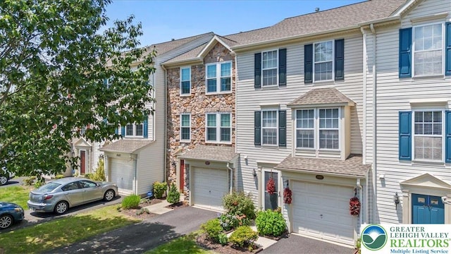 4583 Jasmine Dr, Upper Saucon Twp, PA 18034 - view of property featuring driveway, a garage, and stone siding