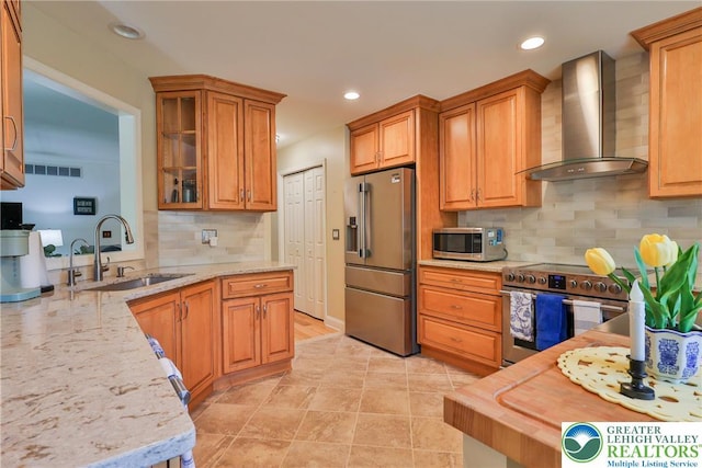 4691 Hampshire Dr, Hanover Twp, PA 18017 - kitchen featuring stainless steel appliances, wall chimney range hood, light stone countertops, decorative backsplash, and recessed lighting