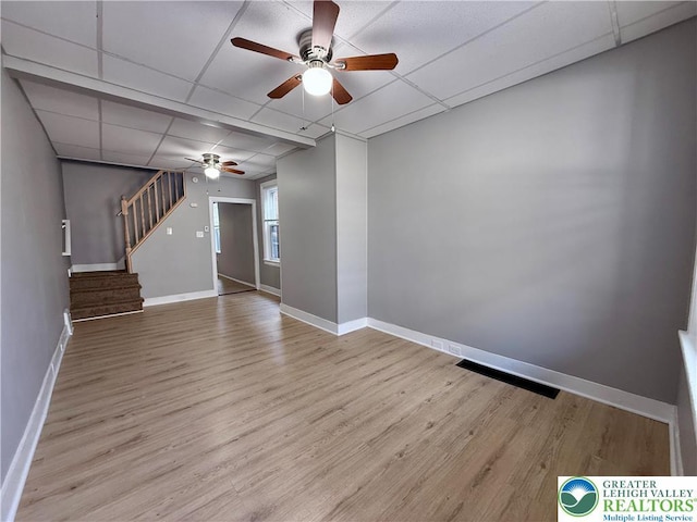 115 W Frankford St, Bethlehem City, PA 18018 - unfurnished living room featuring a ceiling fan, a drop ceiling, stairs, and wood finished floors