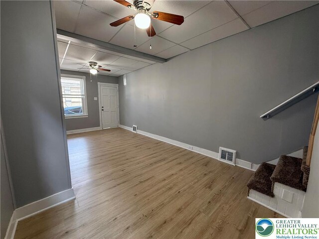 115 W Frankford St, Bethlehem City, PA 18018 - unfurnished living room featuring a ceiling fan, a drop ceiling, wood finished floors, and stairs