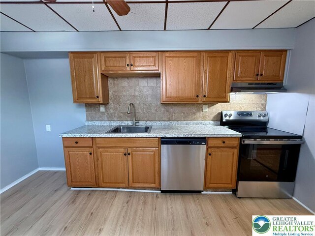 115 W Frankford St, Bethlehem City, PA 18018 - kitchen featuring stainless steel appliances, under cabinet range hood, a paneled ceiling, light wood finished floors, and decorative backsplash