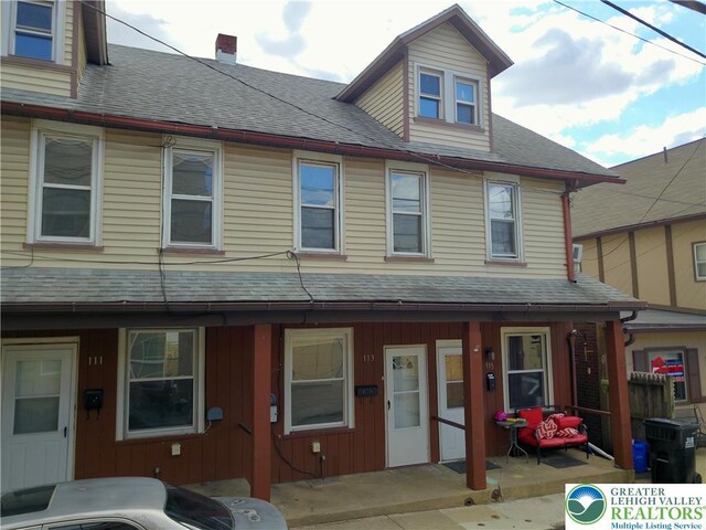 115 W Frankford St, Bethlehem City, PA 18018 - view of property featuring roof with shingles, a chimney, and a porch