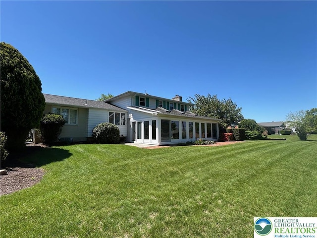 4941 Glenview St, North Whitehall Twp, PA 18078 - rear view of property with a yard, a sunroom, and a chimney