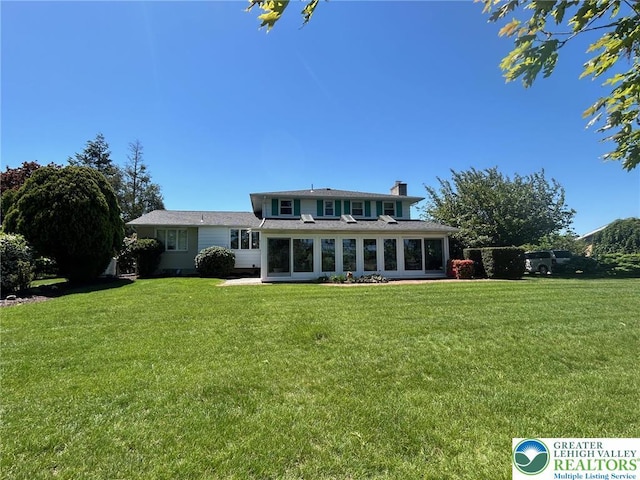 4941 Glenview St, North Whitehall Twp, PA 18078 - rear view of property with a chimney, a lawn, and a sunroom