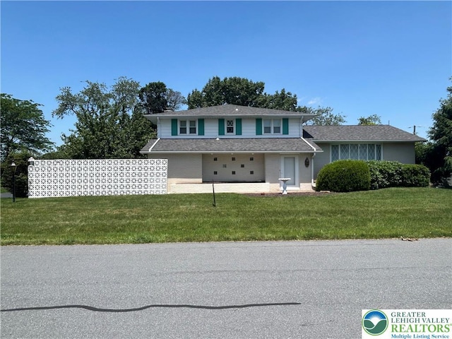 4941 Glenview St, North Whitehall Twp, PA 18078 - view of front of house featuring a front yard, a shingled roof, a garage, and brick siding