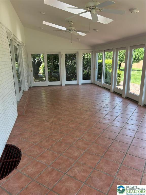 4941 Glenview St, North Whitehall Twp, PA 18078 - unfurnished sunroom with a skylight, vaulted ceiling, and tile patterned flooring