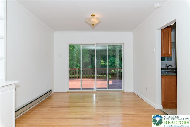 4015 Sycamore Dr, Lehigh Twp, PA 18067 - unfurnished room with baseboard heating, crown molding, light wood-type flooring, and a smoke detector