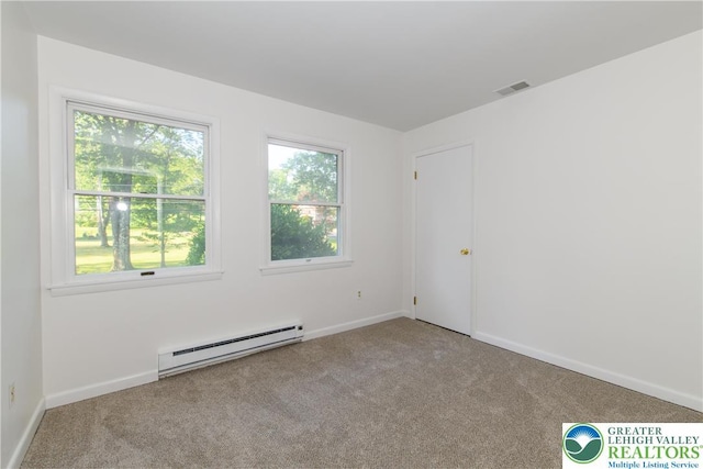4015 Sycamore Dr, Lehigh Twp, PA 18067 - carpeted empty room with a baseboard heating unit and healthy amount of natural light