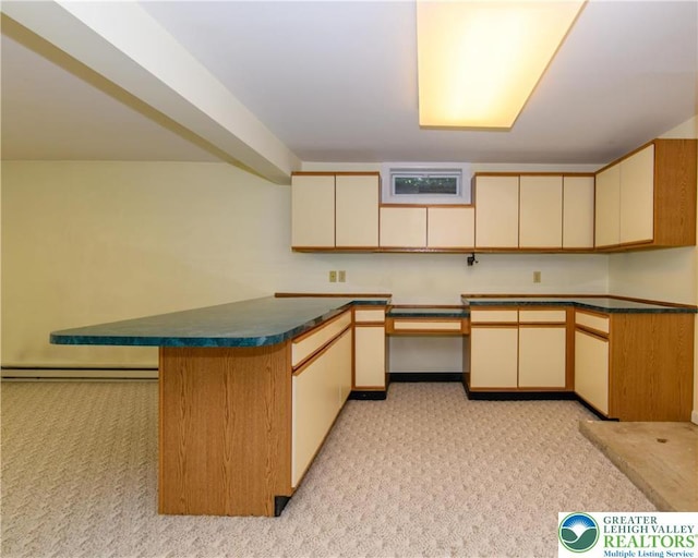 4015 Sycamore Dr, Lehigh Twp, PA 18067 - kitchen featuring cream cabinetry, light colored carpet, baseboard heating, a peninsula, and dark countertops