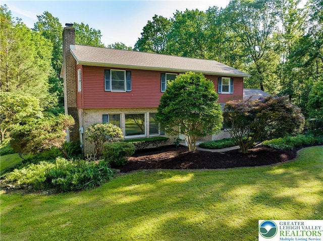 4015 Sycamore Dr, Lehigh Twp, PA 18067 - view of front of property with a chimney, a front lawn, and brick siding