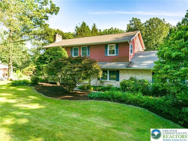 4015 Sycamore Dr, Lehigh Twp, PA 18067 - view of front of property with a chimney, a front lawn, a shingled roof, and brick siding