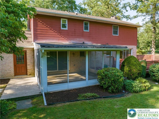 4015 Sycamore Dr, Lehigh Twp, PA 18067 - back of house with brick siding, a sunroom, and a lawn