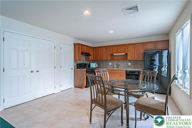 26 Chestnut Commons Ct, Easton, PA 18040 - kitchen with black appliances, backsplash, light tile patterned flooring, light countertops, and brown cabinets