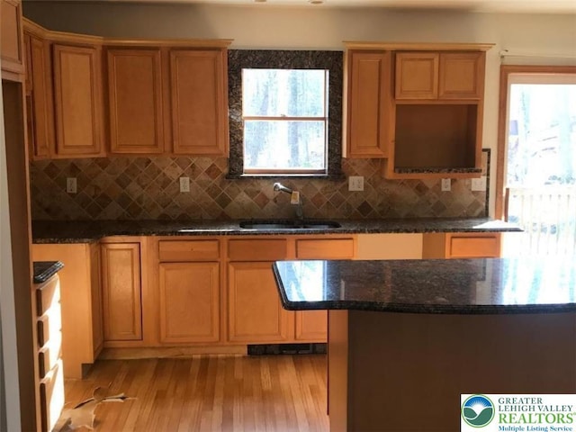 217 St Andrews Dr, Middle Smithfield Twp, PA 18324 - kitchen featuring healthy amount of natural light, light wood-type flooring, dark stone counters, and decorative backsplash