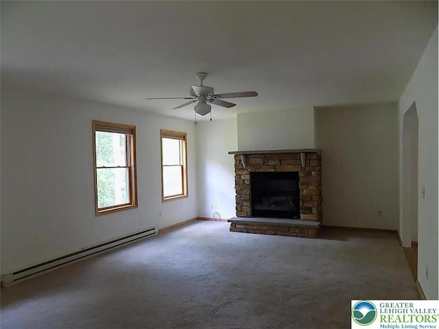 217 St Andrews Dr, Middle Smithfield Twp, PA 18324 - unfurnished living room with a baseboard heating unit, a ceiling fan, carpet, and a stone fireplace