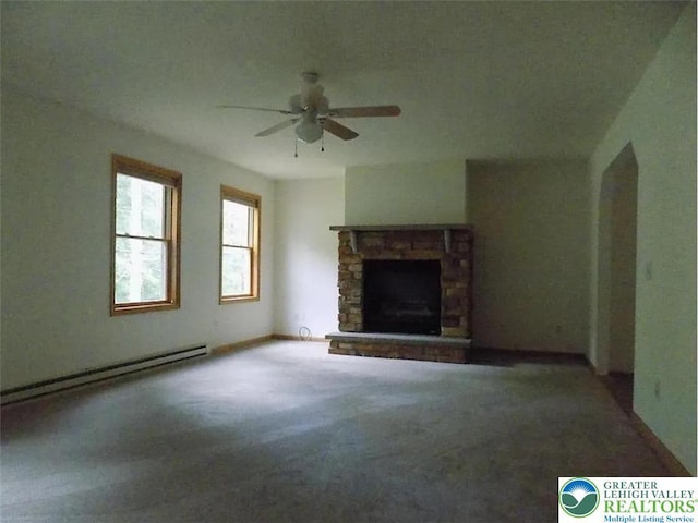 217 St Andrews Dr, Middle Smithfield Twp, PA 18324 - unfurnished living room with baseboard heating, ceiling fan, a stone fireplace, and carpet