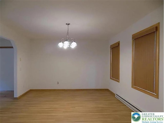 217 St Andrews Dr, Middle Smithfield Twp, PA 18324 - unfurnished room with a baseboard heating unit, light wood-style floors, arched walkways, and a chandelier