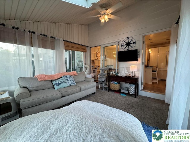 7 Madison Ln, Whitehall Twp, PA 18052 - carpeted living area featuring ceiling fan, lofted ceiling, and wooden walls