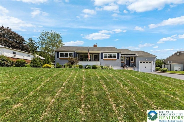320 Nulton Ave, Palmer Twp, PA 18045 - view of front facade featuring asphalt driveway, an attached garage, a front lawn, and a chimney