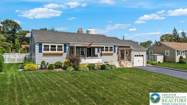 320 Nulton Ave, Palmer Twp, PA 18045 - view of front of property featuring a garage, driveway, a chimney, and a storage shed