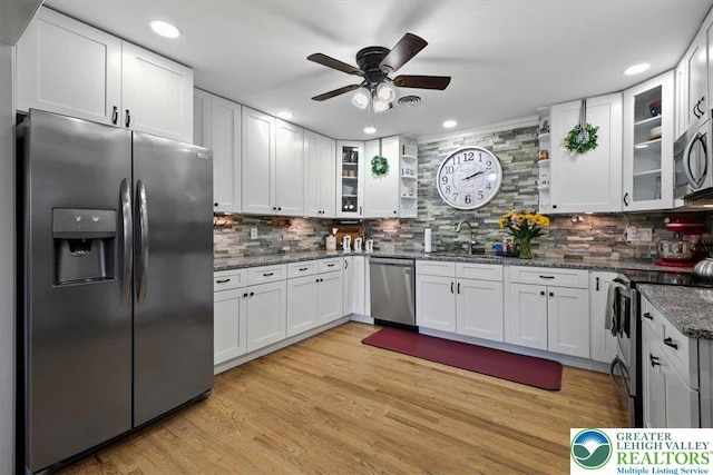 320 Nulton Ave, Palmer Twp, PA 18045 - kitchen with stainless steel appliances, ceiling fan, backsplash, white cabinetry, and dark stone countertops