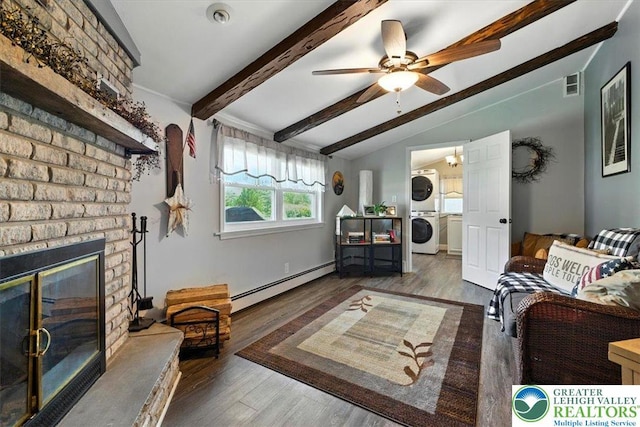 320 Nulton Ave, Palmer Twp, PA 18045 - living area with stacked washing machine and dryer, a baseboard heating unit, a ceiling fan, wood finished floors, and a fireplace