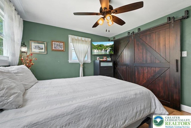320 Nulton Ave, Palmer Twp, PA 18045 - bedroom featuring a barn door, wood finished floors, and ceiling fan