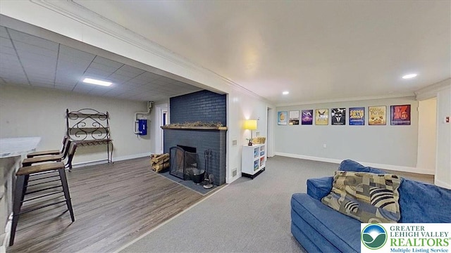 320 Nulton Ave, Palmer Twp, PA 18045 - living area with a brick fireplace, wood finished floors, ornamental molding, and recessed lighting