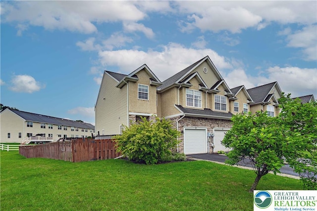 301 Maple Ct, Alburtis Boro, PA 18011 - view of front of home with stone siding, asphalt driveway, a garage, and stucco siding
