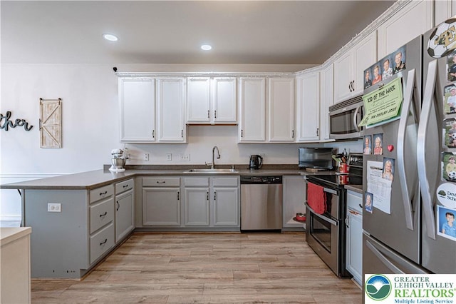 301 Maple Ct, Alburtis Boro, PA 18011 - kitchen featuring stainless steel appliances, a peninsula, white cabinets, light wood finished floors, and recessed lighting