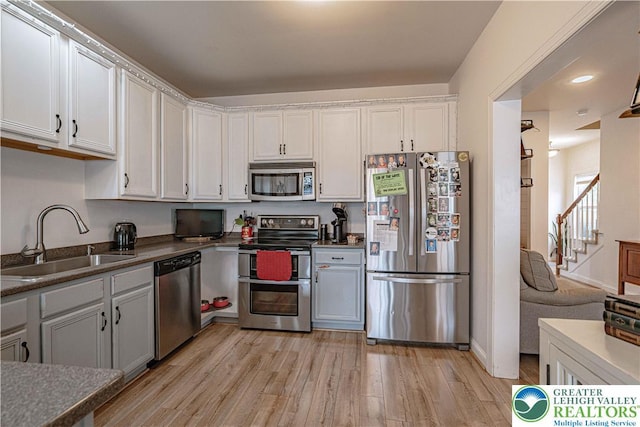 301 Maple Ct, Alburtis Boro, PA 18011 - kitchen featuring appliances with stainless steel finishes, light wood-style floors, white cabinetry, dark countertops, and recessed lighting