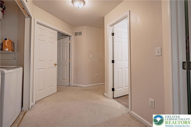 301 Maple Ct, Alburtis Boro, PA 18011 - corridor with washer / dryer and light carpet