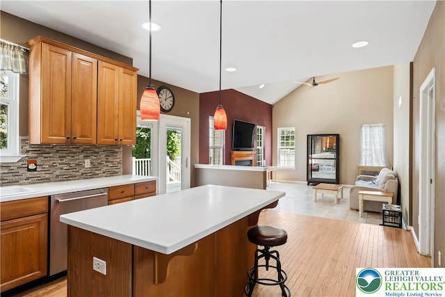 2535 Clark Pl, Forks Twp, PA 18040 - kitchen with stainless steel dishwasher, open floor plan, light countertops, a breakfast bar area, and vaulted ceiling