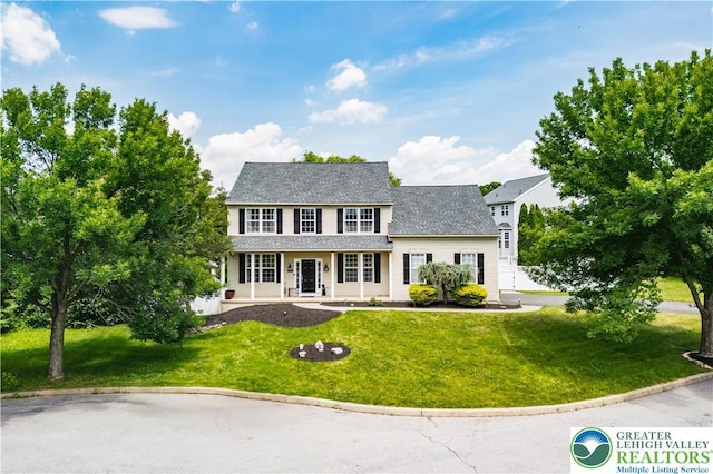 2535 Clark Pl, Forks Twp, PA 18040 - colonial home featuring a front lawn, covered porch, and roof with shingles