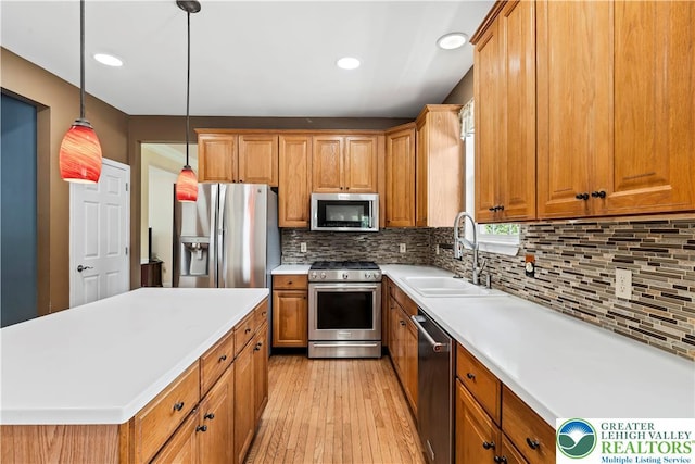 2535 Clark Pl, Forks Twp, PA 18040 - kitchen with appliances with stainless steel finishes, brown cabinetry, light wood-style floors, light countertops, and tasteful backsplash