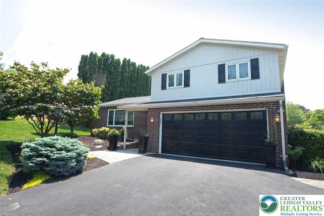 5801 Keith Ln, Upper Milford Twp, PA 18049 - view of front of property with brick siding, asphalt driveway, and a garage
