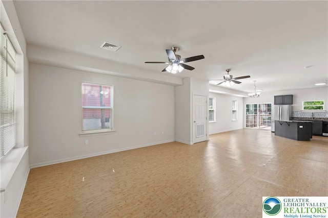 271 W Fairview St W, Bethlehem City, PA 18018 - unfurnished living room featuring light wood-style flooring, a chandelier, and a ceiling fan