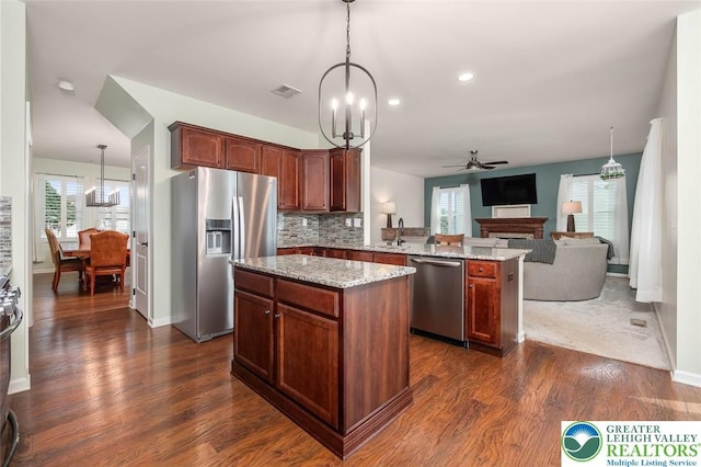 2186 Eagles Landing Dr, Upper Nazareth Twp, PA 18064 - kitchen featuring stainless steel appliances, a peninsula, open floor plan, a center island, and a ceiling fan