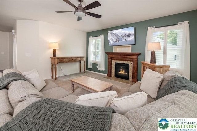 2186 Eagles Landing Dr, Upper Nazareth Twp, PA 18064 - carpeted living room with healthy amount of natural light, a ceiling fan, and a high end fireplace