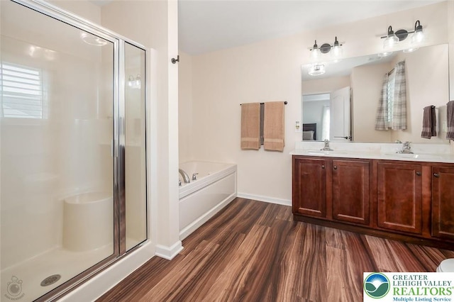 2186 Eagles Landing Dr, Upper Nazareth Twp, PA 18064 - full bath featuring wood finished floors, a shower stall, double vanity, and a garden tub