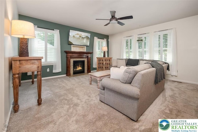 2186 Eagles Landing Dr, Upper Nazareth Twp, PA 18064 - carpeted living room featuring ceiling fan and a fireplace with flush hearth